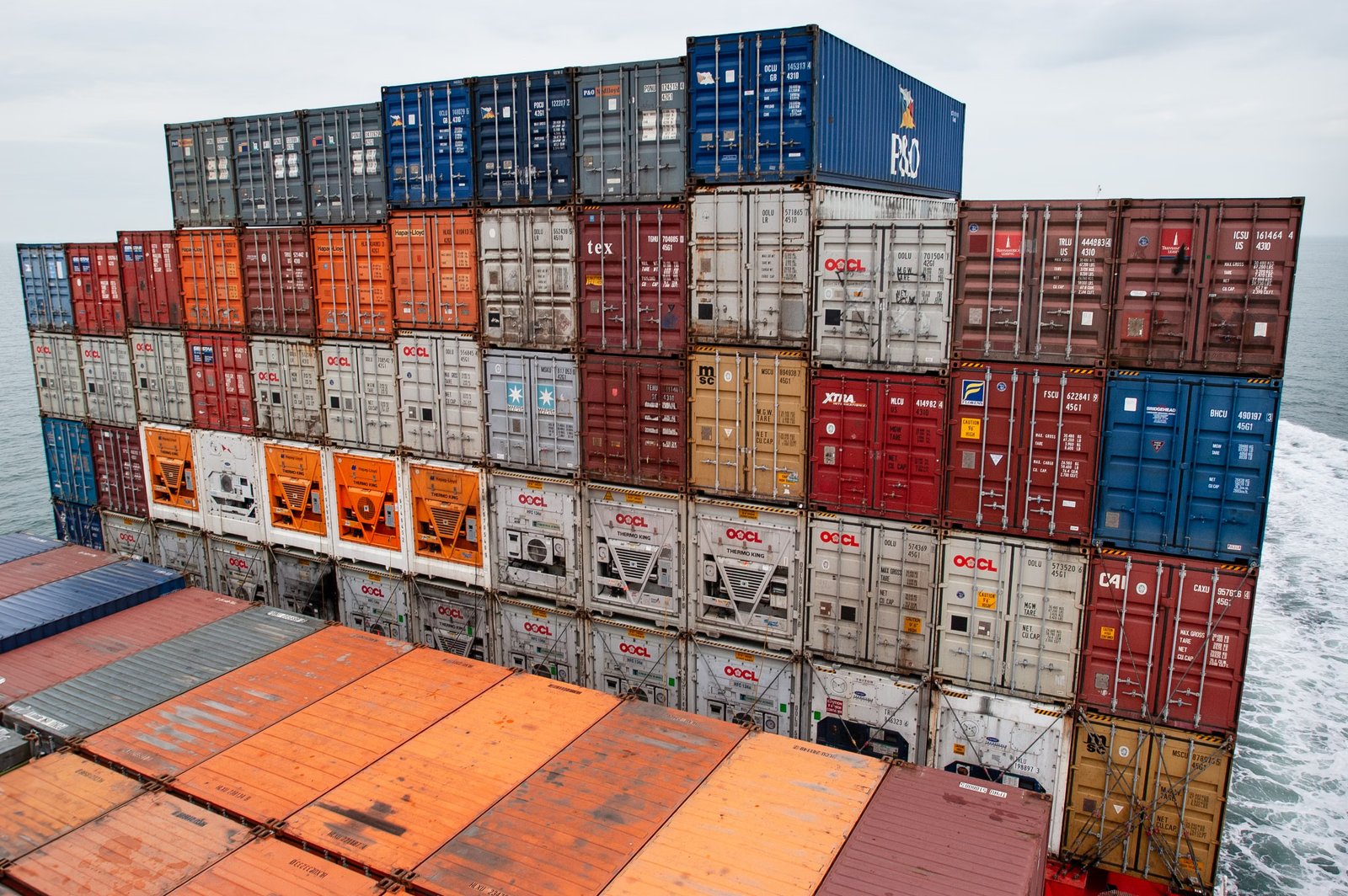 Global shipping containers stacked at cargo port